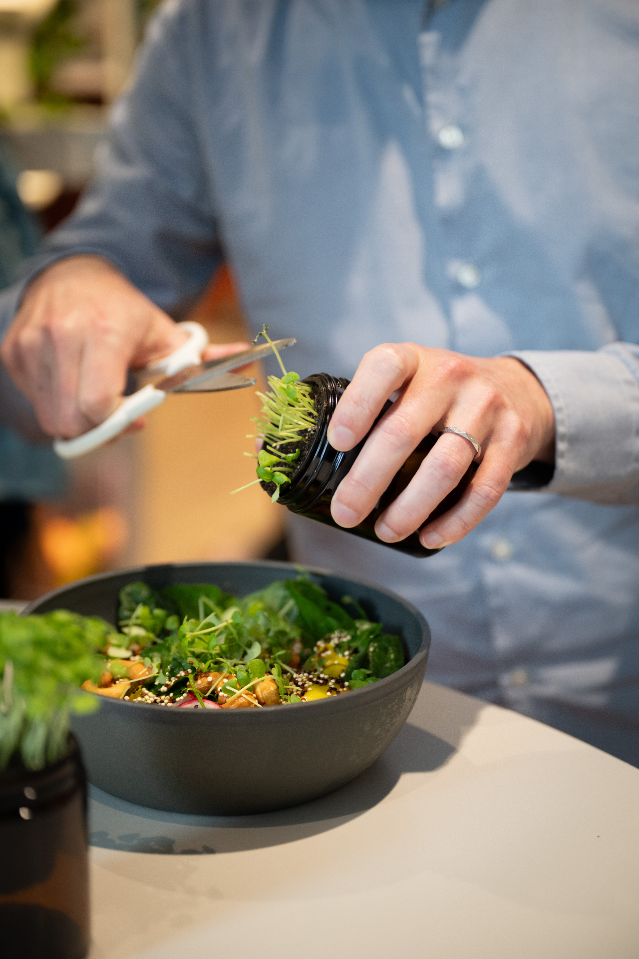 Snipping fresh microgreens onto a dish